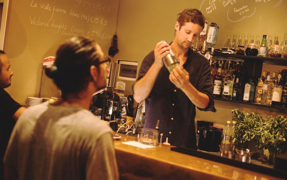 Tom Devenish shaking a cocktail on opening night